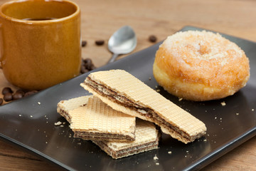 coffee and wafer stick and donuts sugar