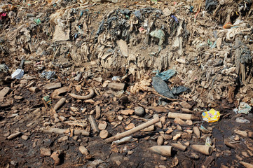 Garbage, household trash, plastic bags and toxic industrial waste on contaminated land and water at a polluted landfill site in Bali, Indonesia.