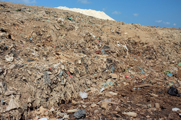 Garbage, household trash, plastic bags and toxic industrial waste next to contaminated water at a...