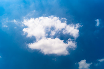 Naklejka na ściany i meble White cloud in the blue sky.