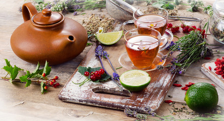 Fototapeta na wymiar Herbal tea with herbs, lime and berries
