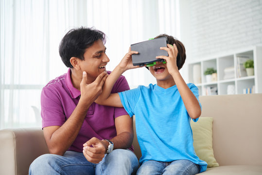 Kid using virtual reality headset at home - Powered by Adobe