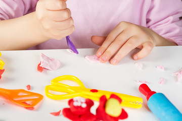 Obraz na płótnie Canvas Child hands with colorful clay