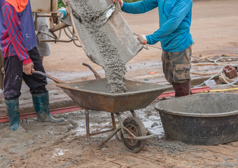 pouring wet cement to cart