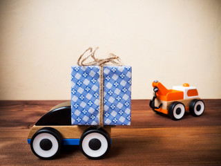 Gift box and toy machinery. Gift delivery service concept. Shallow focus