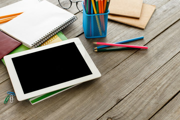 White tablet with blank screen and office supplies