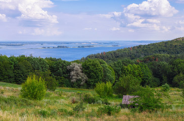 Fototapeta na wymiar Beautiful summer landscape with river and blue sky with clouds