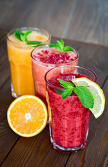 Assorted fruit smoothies on a wooden table. smoothies concept