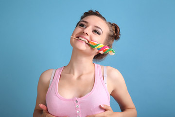 Young happy girl with colored candy