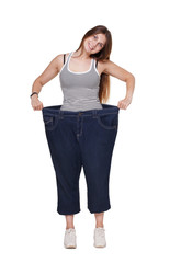 Obraz premium Young woman happy of weight loss diet results, isolated