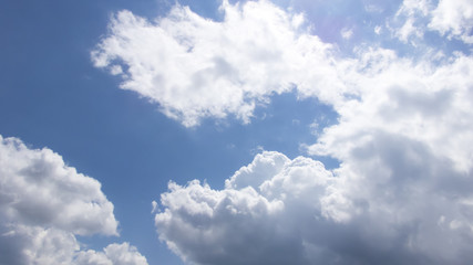 Fototapeta na wymiar White clouds in a dark blue sky in Europe