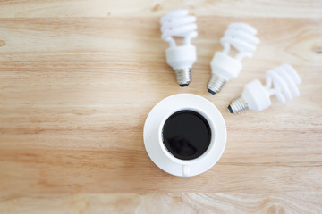 Black coffee in selective focus And blurry lamp. on wood table.