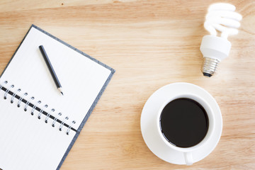 Black coffee on wood table.And brighten lamp.