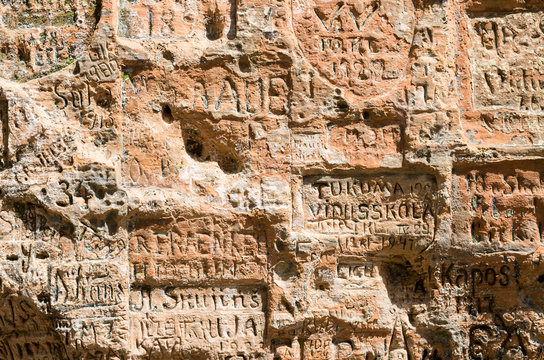 SIGULDA LATVIA - JULY 16 2016: Old inscriptions in the Gautmanis Cave located on the Gauja River