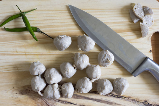 Meat ball on a wooden cutting board and knife.In selective focus