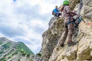Deurstickers Hiker climbing in the mountain of Alps, Europe © Simon Dannhauer