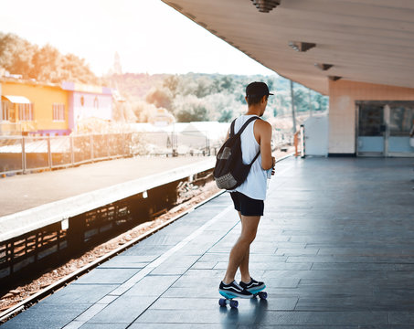 Young man riding on a skate on platform metro.