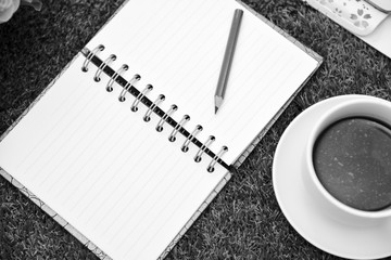 Black and white dark tone .Writing on copy space note book.With