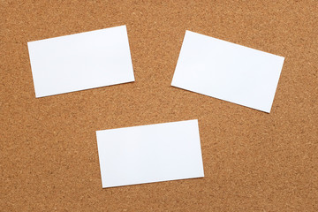 Three blank cards on a cork board