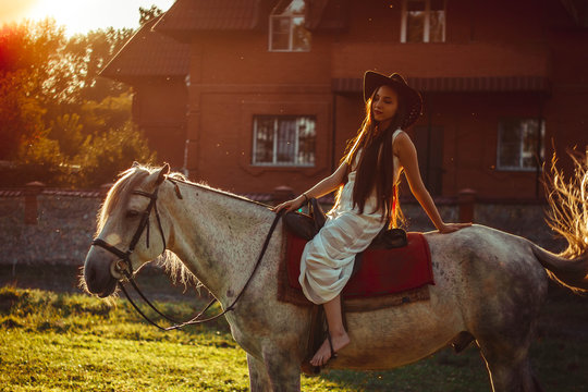 girl on horseback at sunset