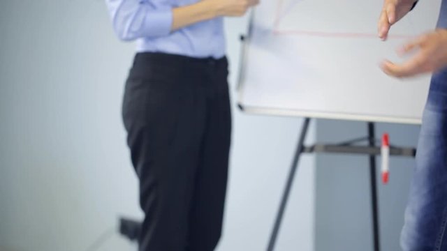 Lector spreads handouts between listeners in conference hall.