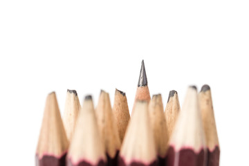 sharped yellow pencil standing out from crowd of blunted black f