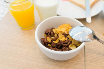 Cornflakes with milk in a white bowl