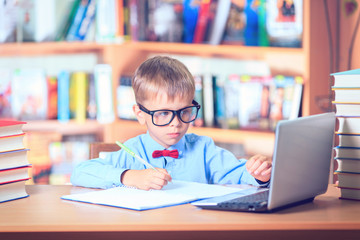 School Kid Studying in Library, Child Writing Paper Copy Book in