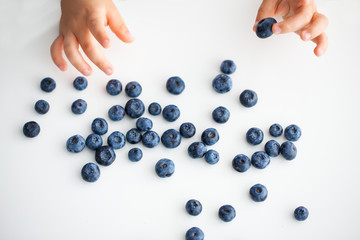 a handful of berries in children's hands