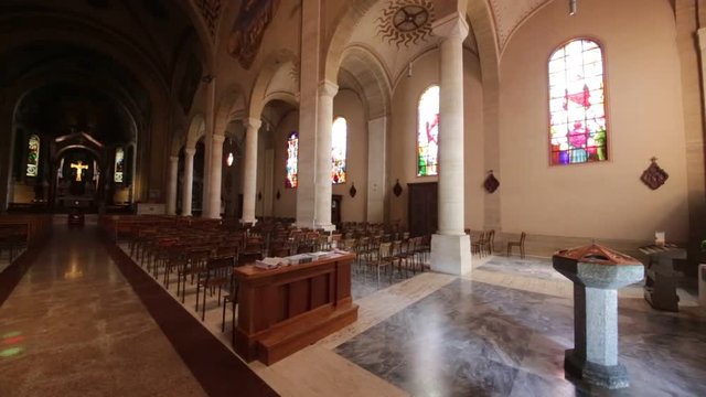 in italy turbigo inside  church religion building the altar chair desk colorated glass and window .