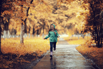Girl 6-7 runs in the autumn park