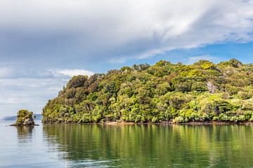 Patterson Inlet, Stewart Island, with trees reflected in the water