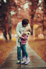 mother hugging her daughter, Autumn Park