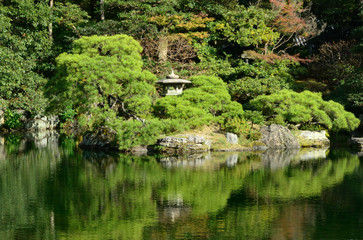 Fototapeta na wymiar Japanese garden, pond and stone lantern. Kyoto Japan.