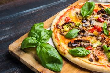 Fresh pizza served on wooden table