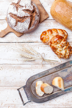 Delicious fresh bread on wooden background