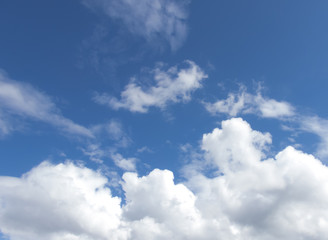 Fototapeta premium White clouds in a dark blue sky in Europe