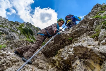 Fototapeten Hiker climbing in the mountain of Alps, Europe © Simon Dannhauer