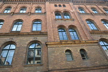 Fototapeta na wymiar Old red brick building many windows