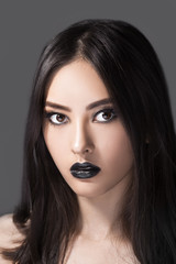Woman beauty fashion portrait with black lips in studio. Asian coasian model