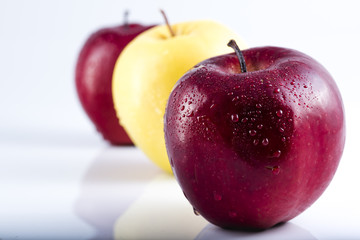 red apple with a yellow apple behind.