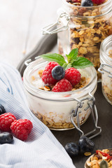 Healthy breakfast - homemade granola and fresh berries on a table, selective focus