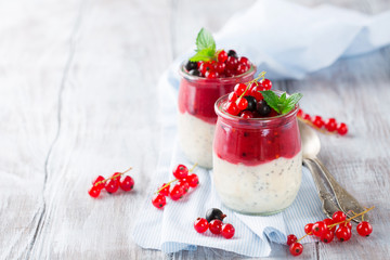 Fresh Berry and chia seeds smoothies on white wooden table, elective focus
