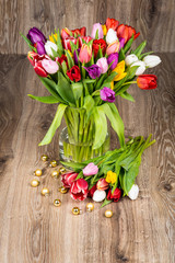 Mix of flowers in the vase on wooden background