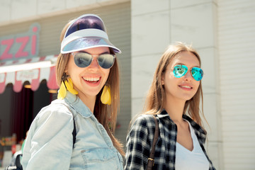 Lifestyle of two best friends laughing outdoor on the street