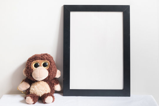 mock up frame and monkey doll in room