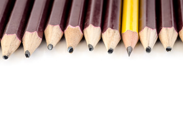 sharped yellow pencil standing out from crowd of blunted black f
