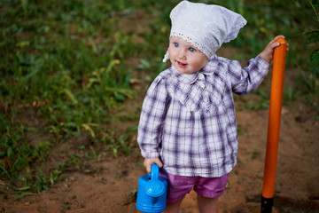 funny boy with shovel in garden