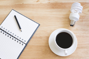 Black coffee on wood table.And lamp.