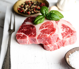 Raw marbled beef on a cutting board,garlic, spices,salt